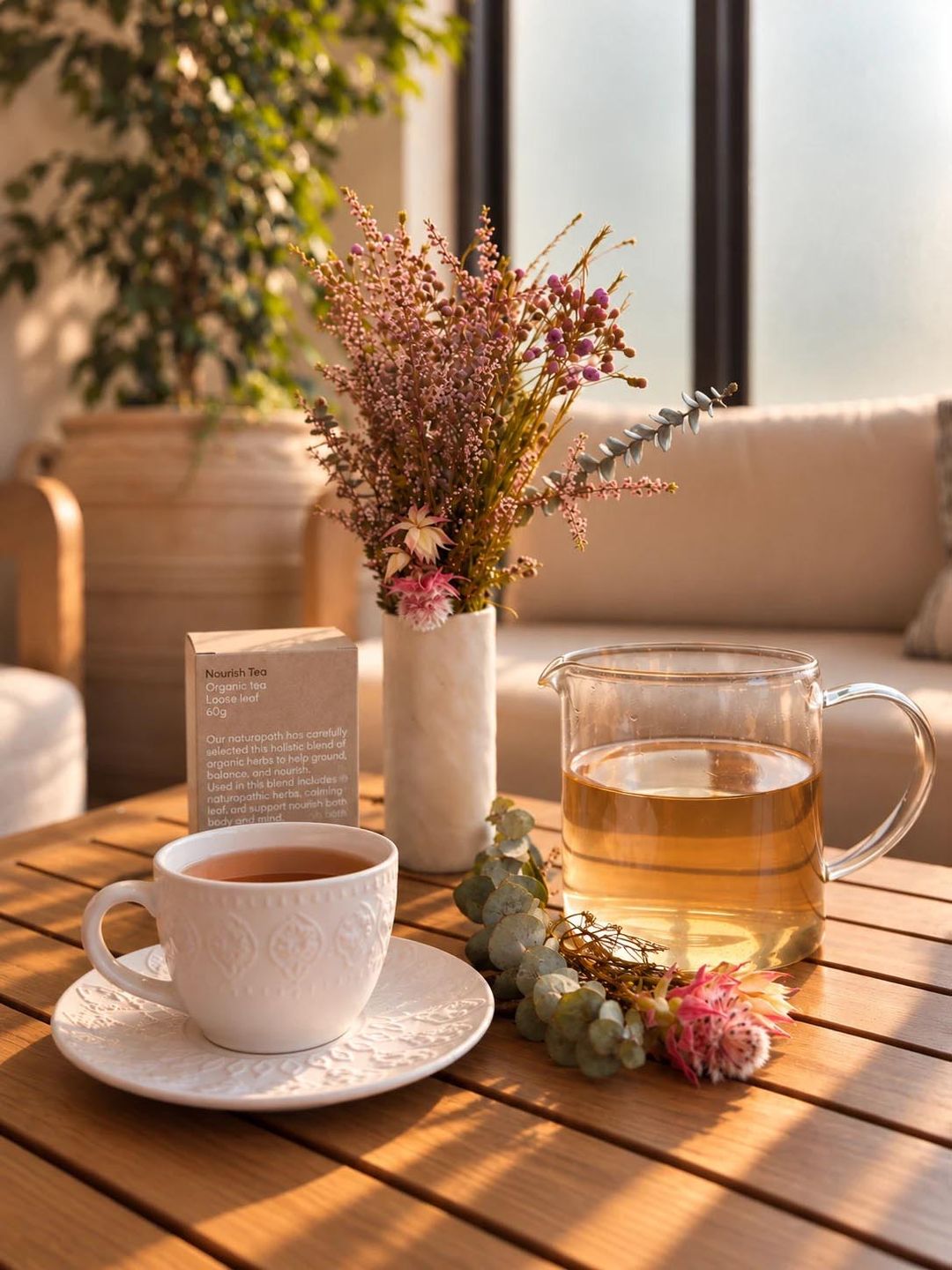 A pot of organic Nourish Tea, blended by our naturopath, poured in the afternoon light
